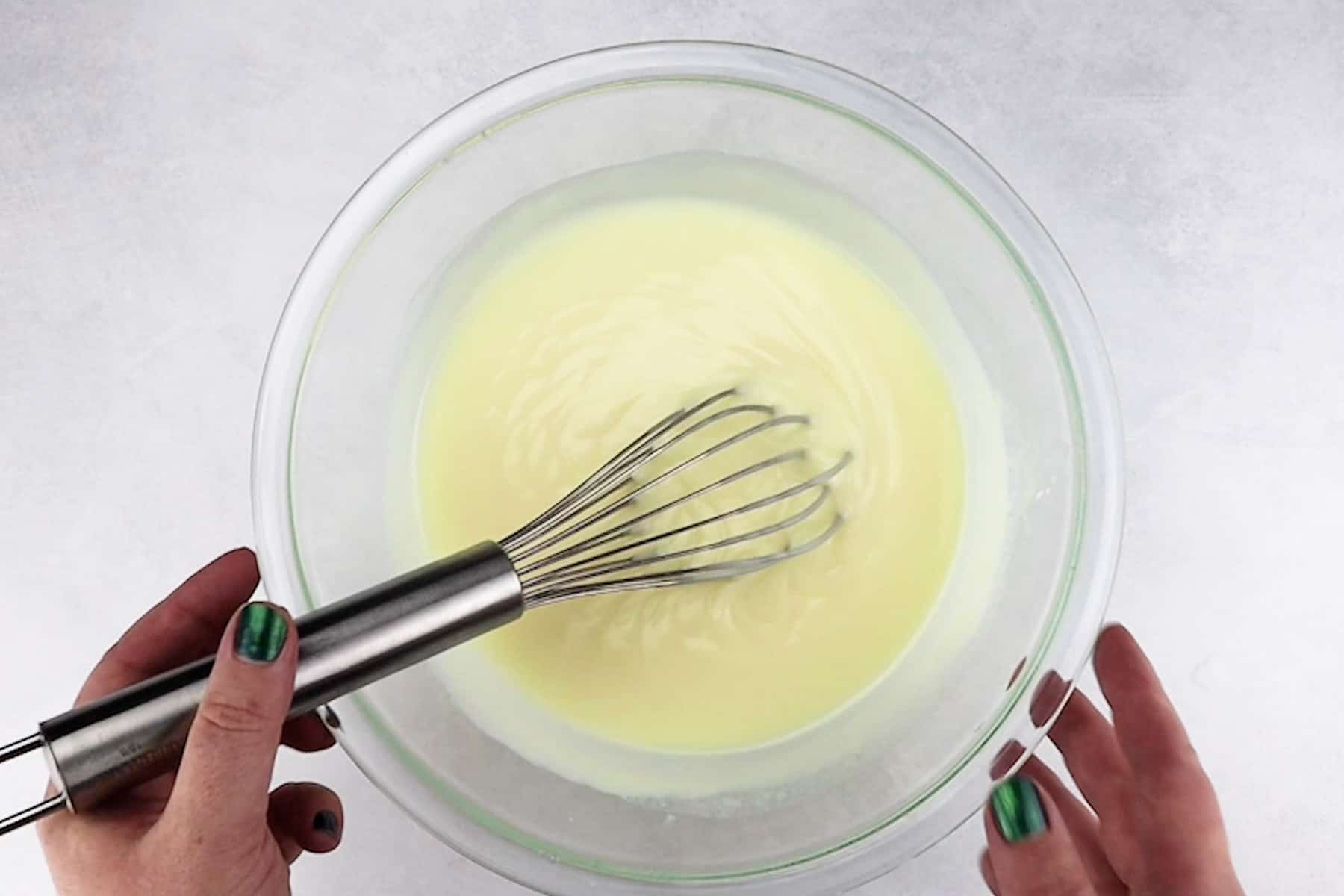 white chocolate pudding mixed in glass bowl.