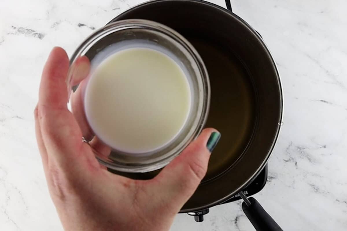 adding milk to pan