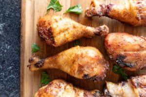 smoked chicken legs on cutting board with parsley