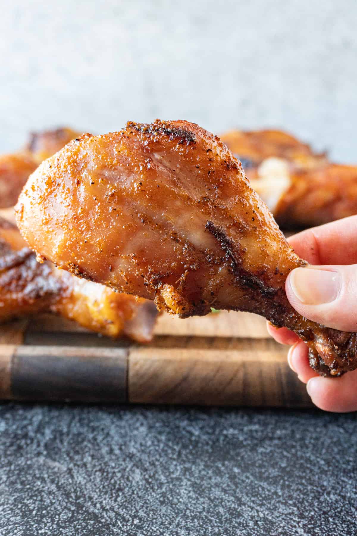 holding a smoked chicken leg