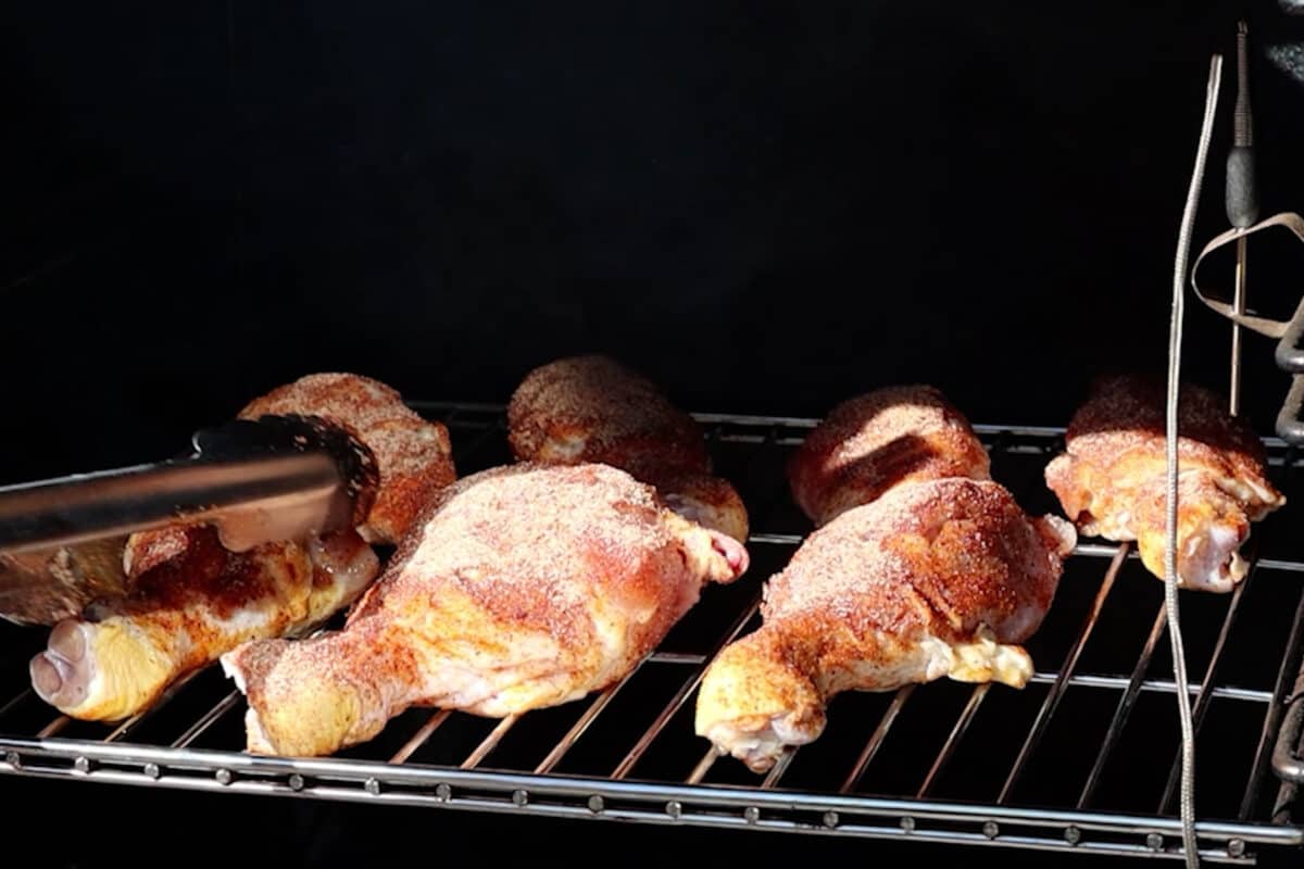 adding chicken legs to smoker