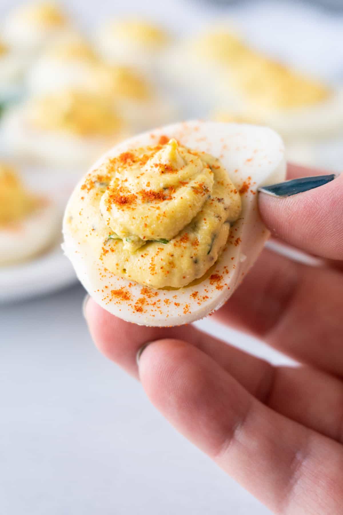 holding a Smoked Deviled Egg