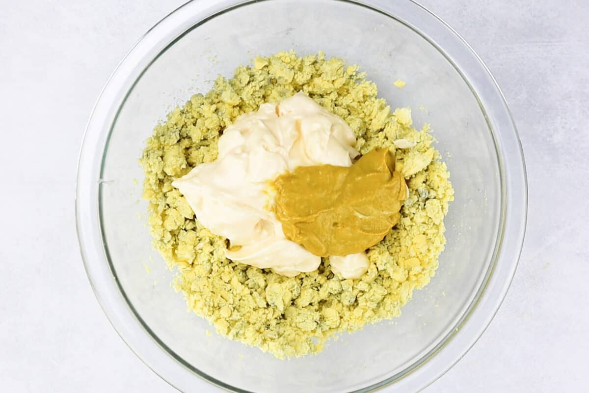 adding mayo and mustard to mashed yolks