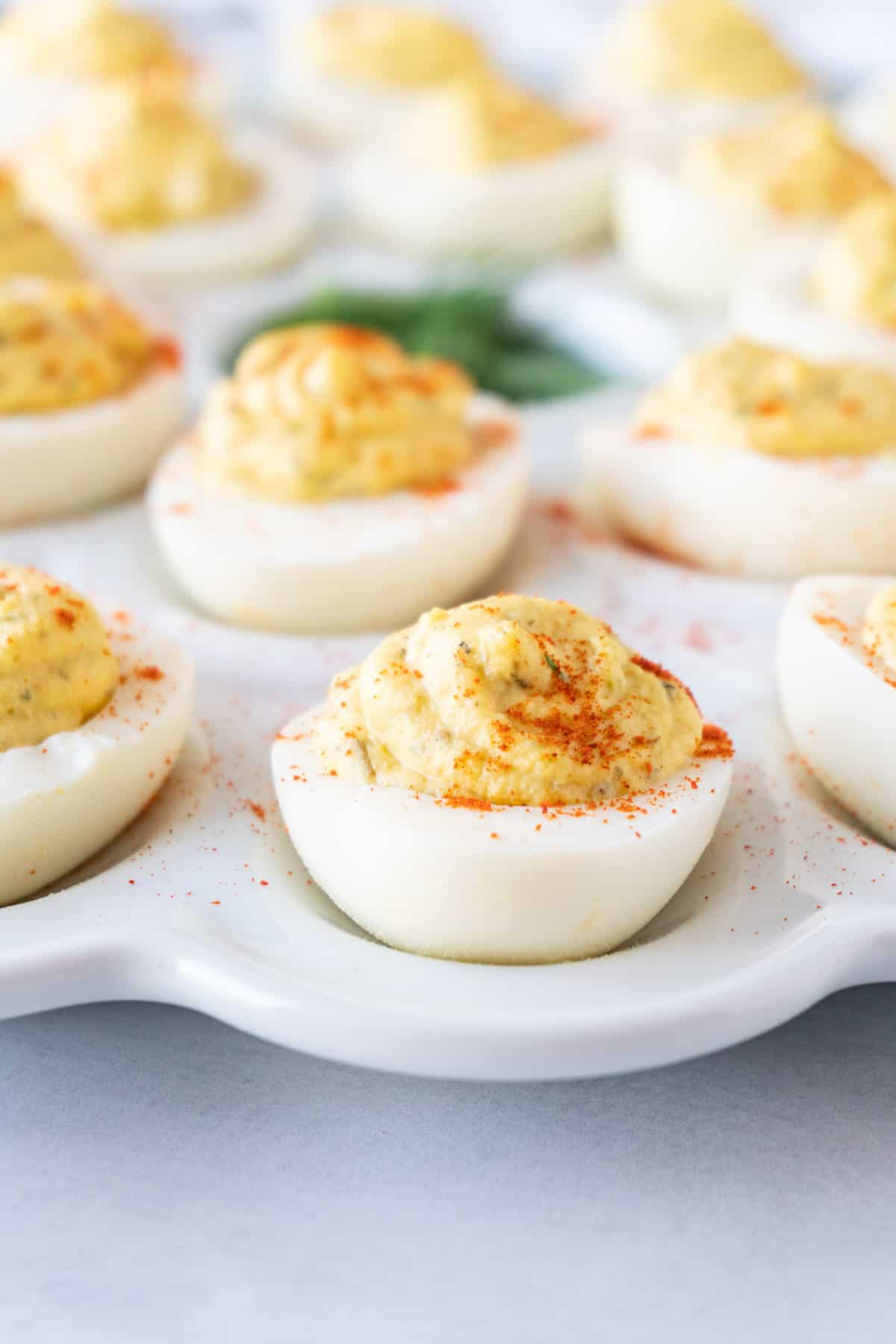 Smoked Deviled Eggs on white platter side view