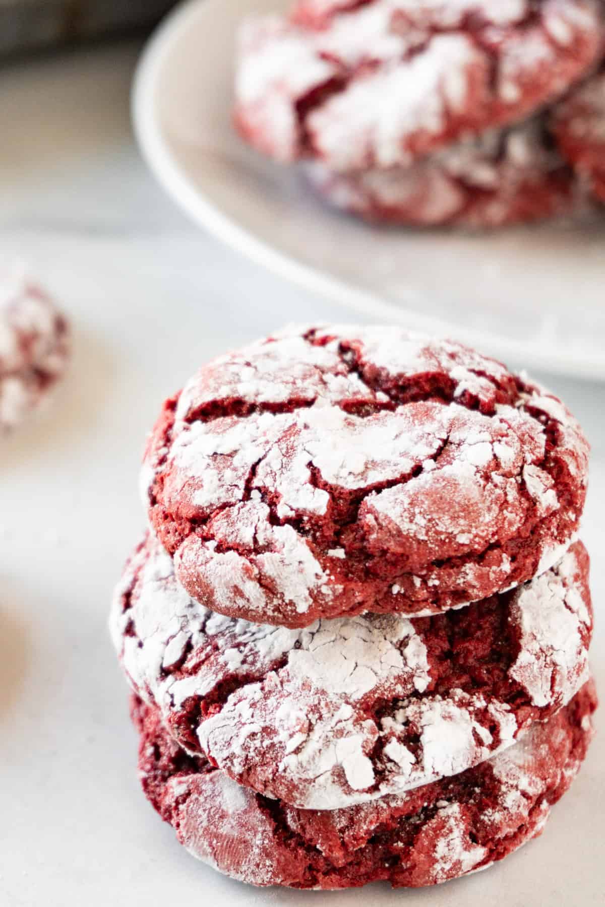 red velvet crinkle cookies stacked on one another