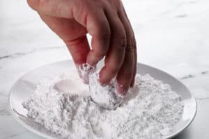 rolling dough in powdered sugar