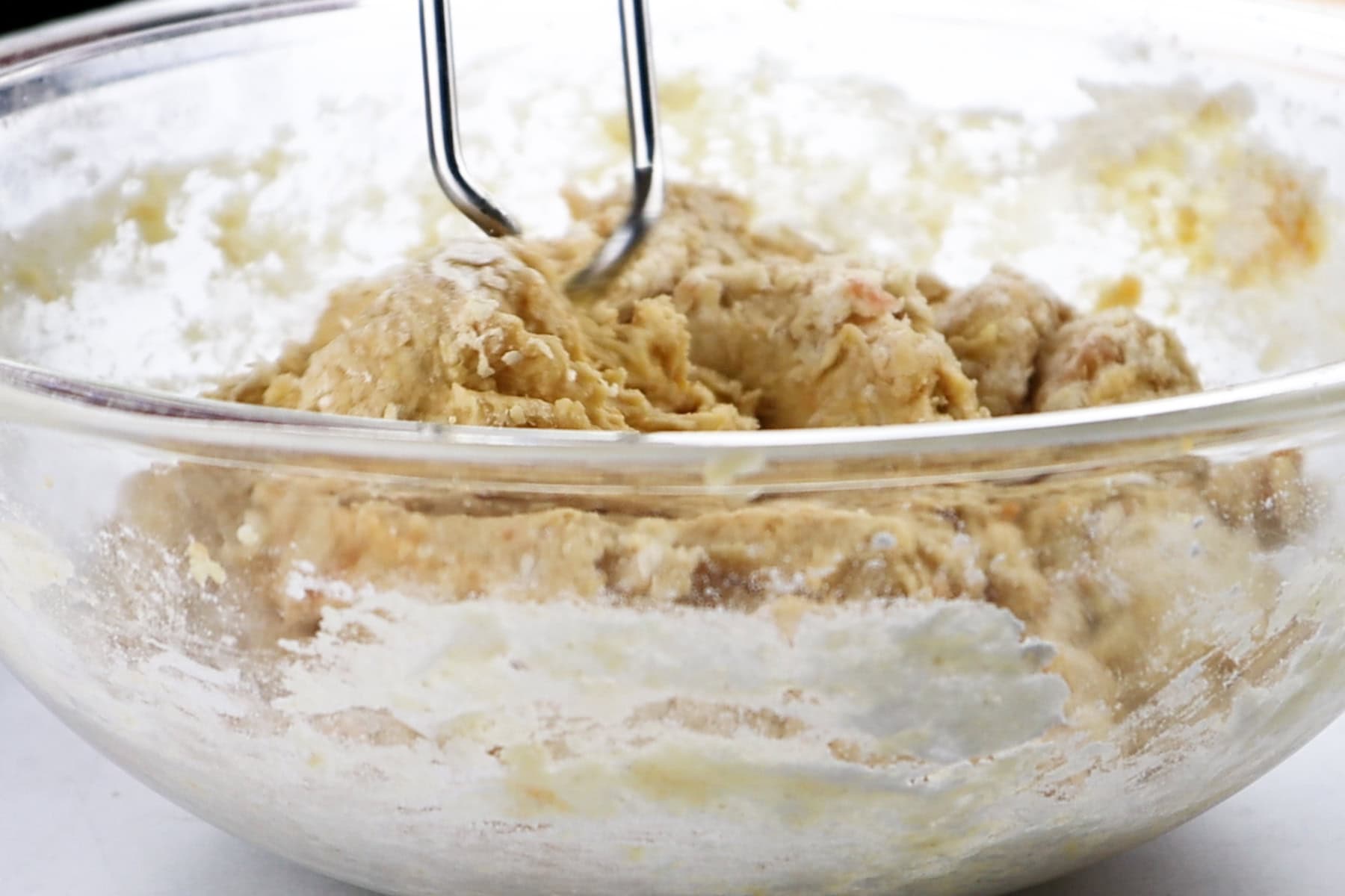 sweet potato rolls dough mixed in a glass bowl.