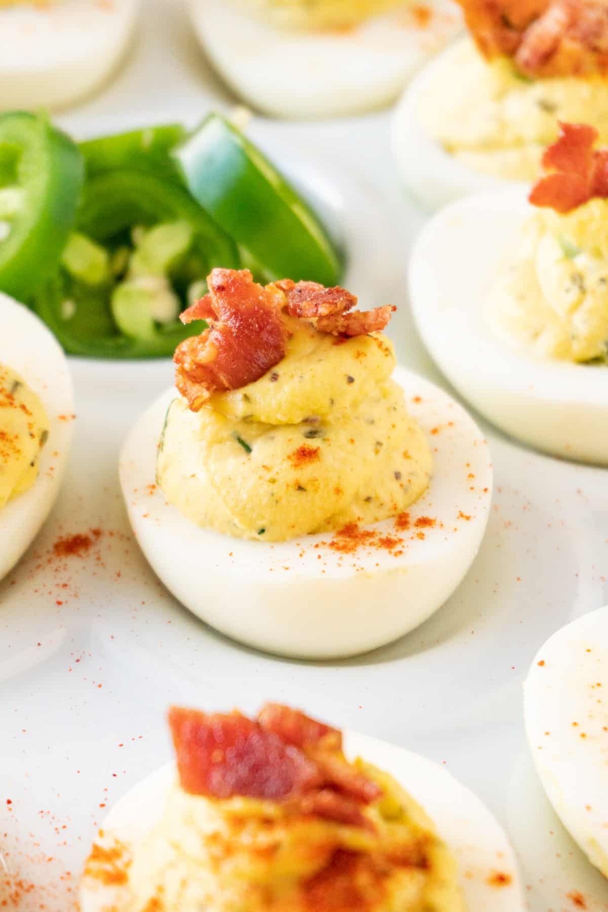 jalapeno deviled egg on tray with jalapenos in center close up