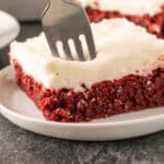red velvet brownie with cream cheese frosting on plate. featured image.