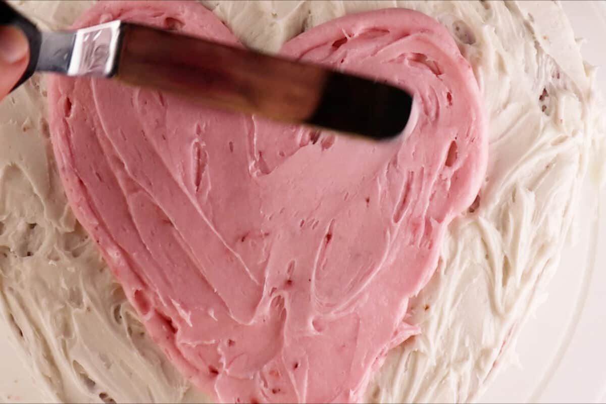 smoothing out heart on top of cake