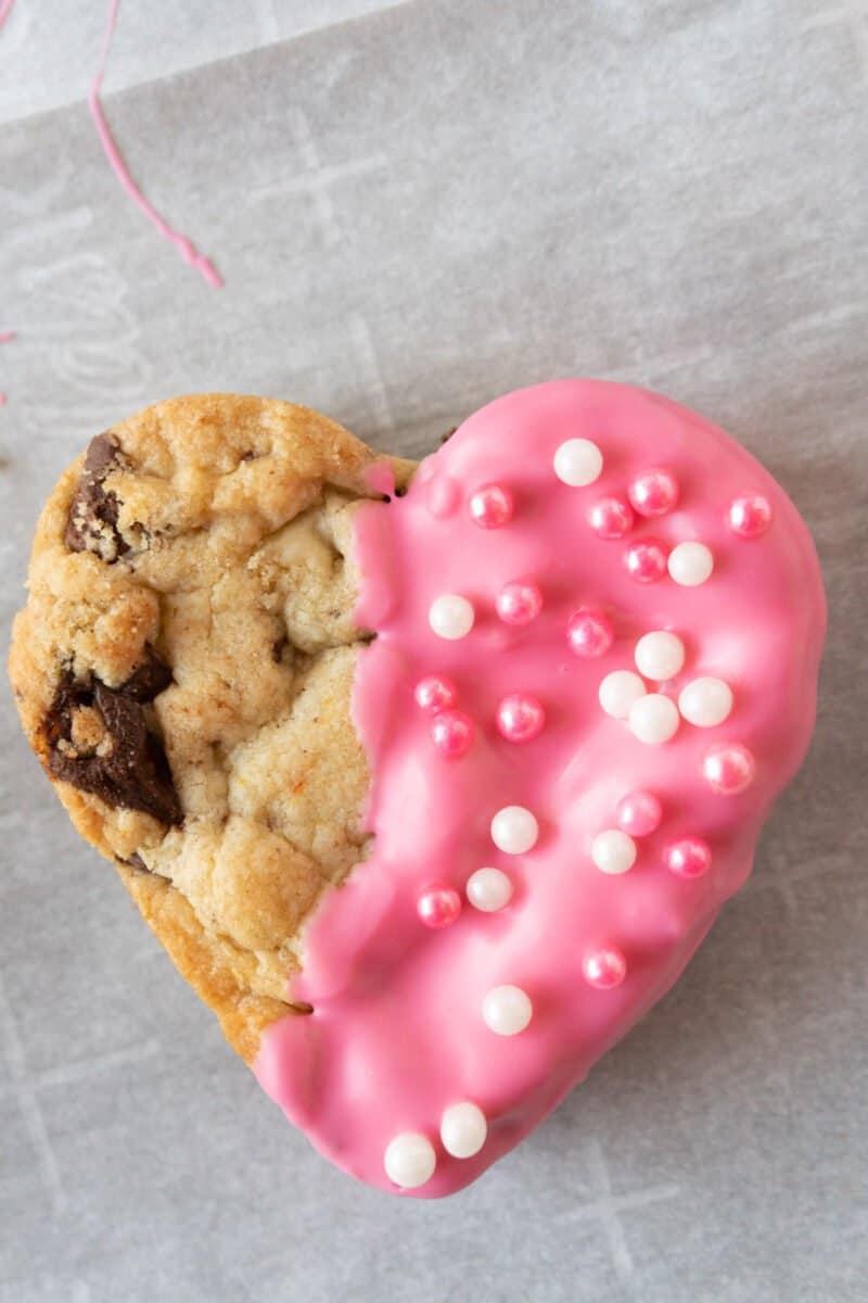heart shaped chocolate chip cookie half pink with spinkles