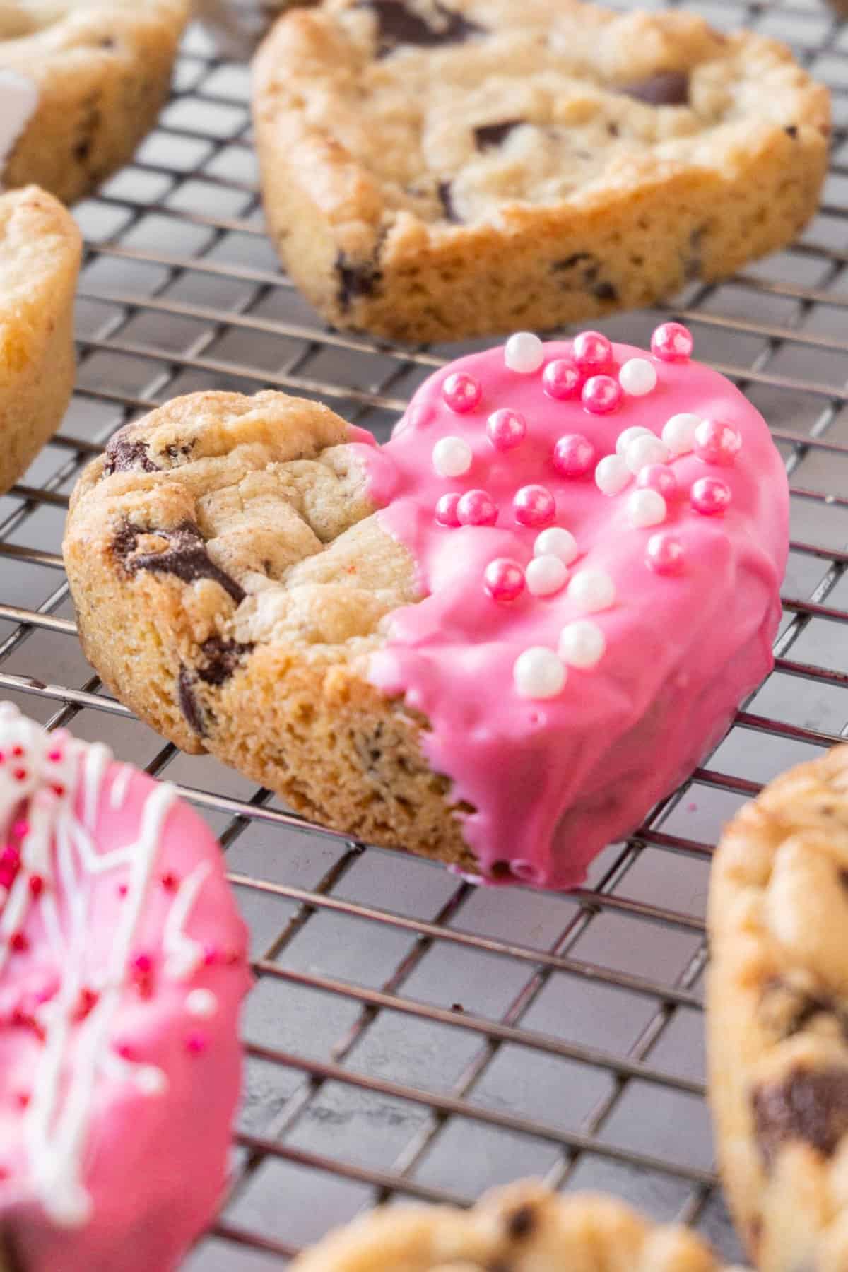 heart shaped chocolate chip cookies on cooling rack some decorated