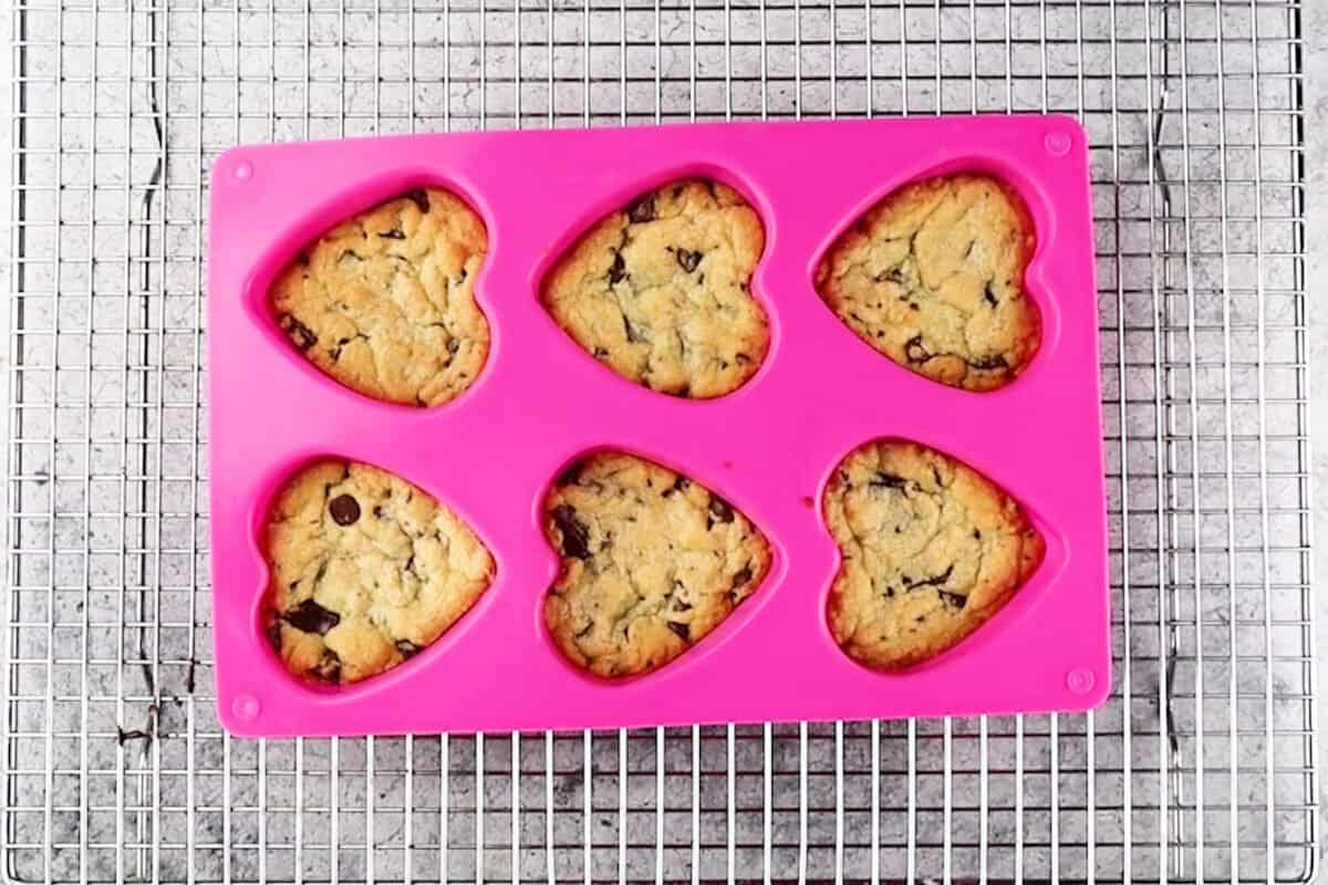 heart shaped chocolate chip cookies after baking still in mold