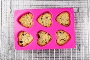 heart shaped chocolate chip cookies after baking still in mold