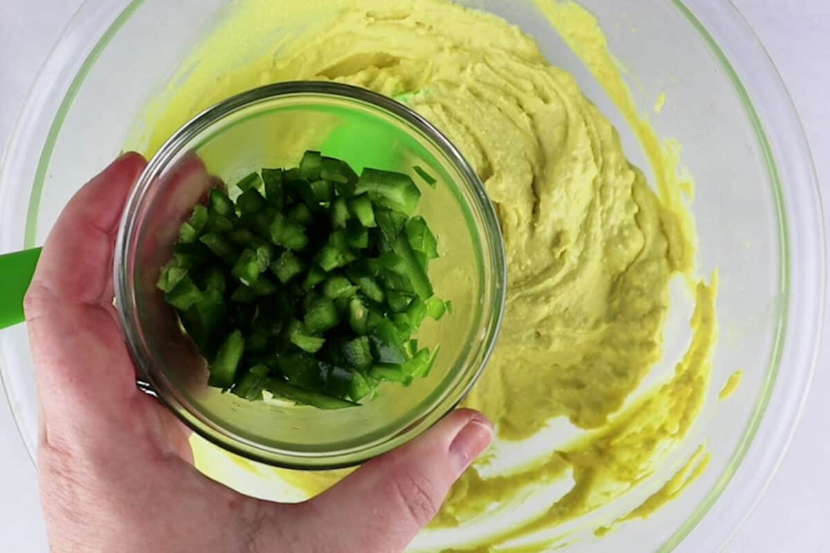 adding jalapenos to yolk mixture