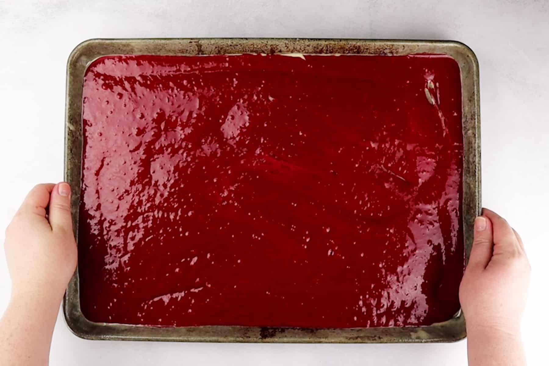 cake batter in sheet pan before baking