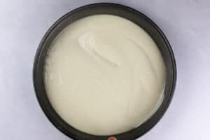 white cake batter in cake pan before baking