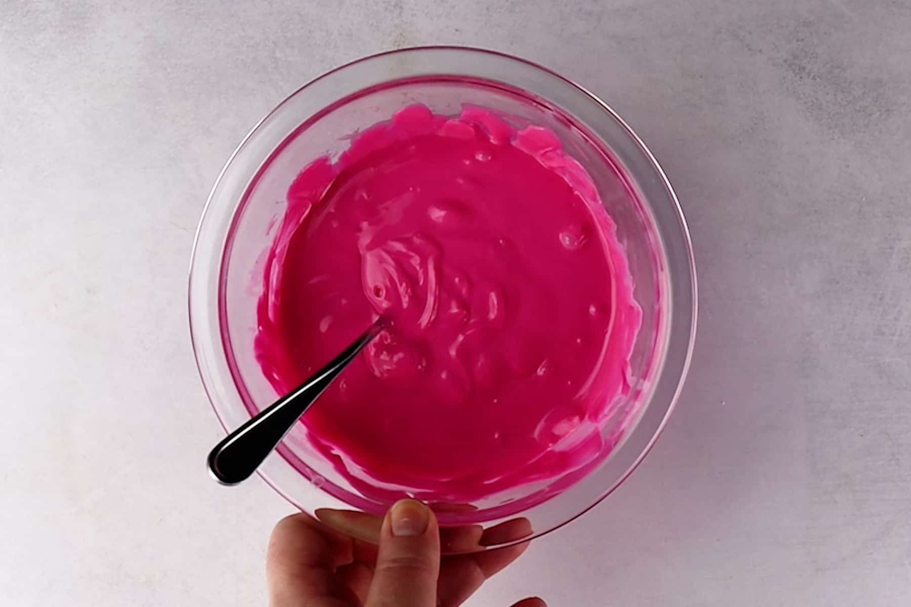 melted pink candy melts in a glass bowl.