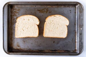 untoasted white bread on baking sheet