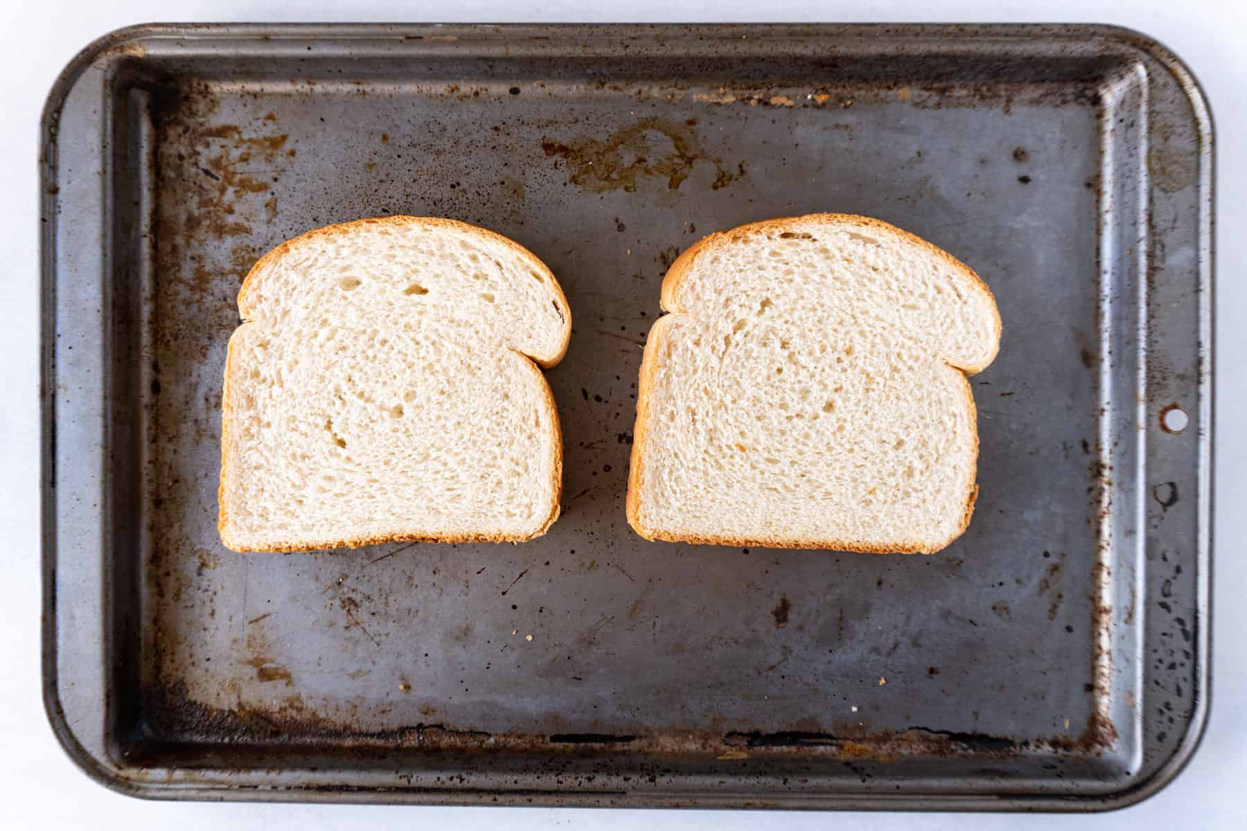 untoasted white bread on baking sheet.