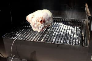 adding turkey to smoker