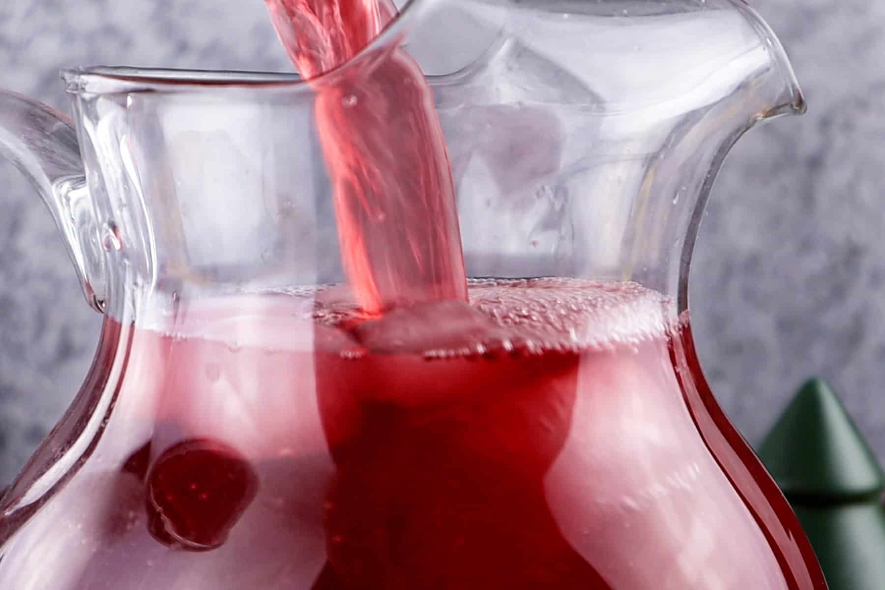 adding cranberry juice to pitcher