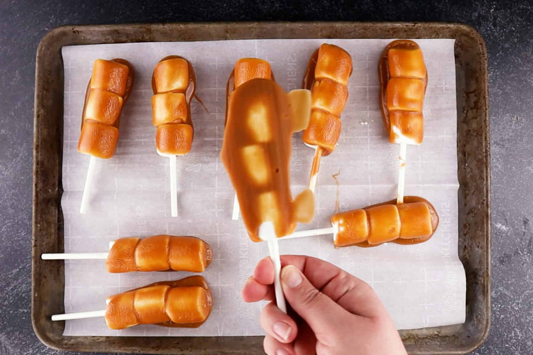 excess caramel needing to be trimmed off marshmallows