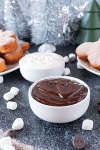 chocolate sauce and whipped cream in bowls