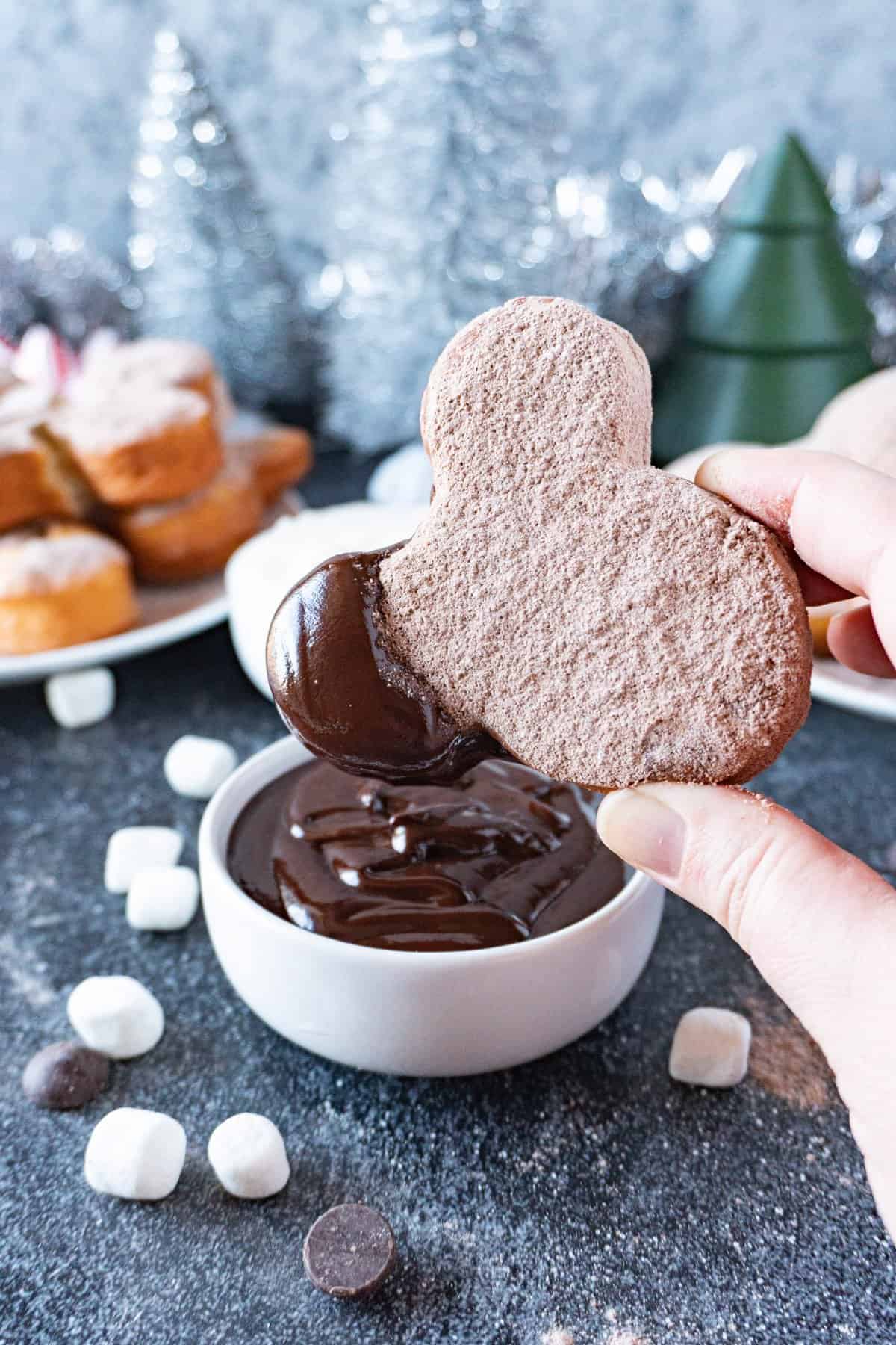 hot cocoa beignets dipped in chocolate sauce