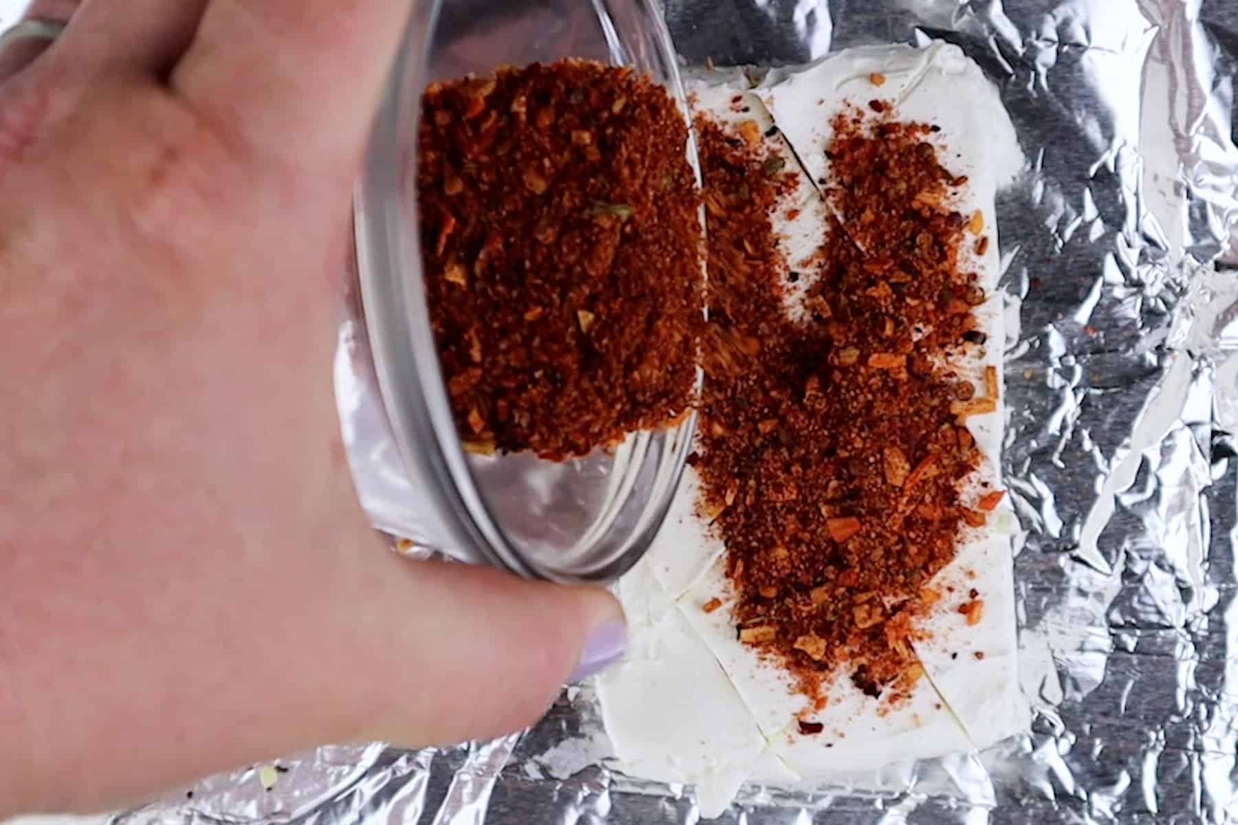 adding seasoning to cream cheese