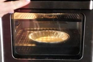 pancake batter in aluminum pan in air fryer.