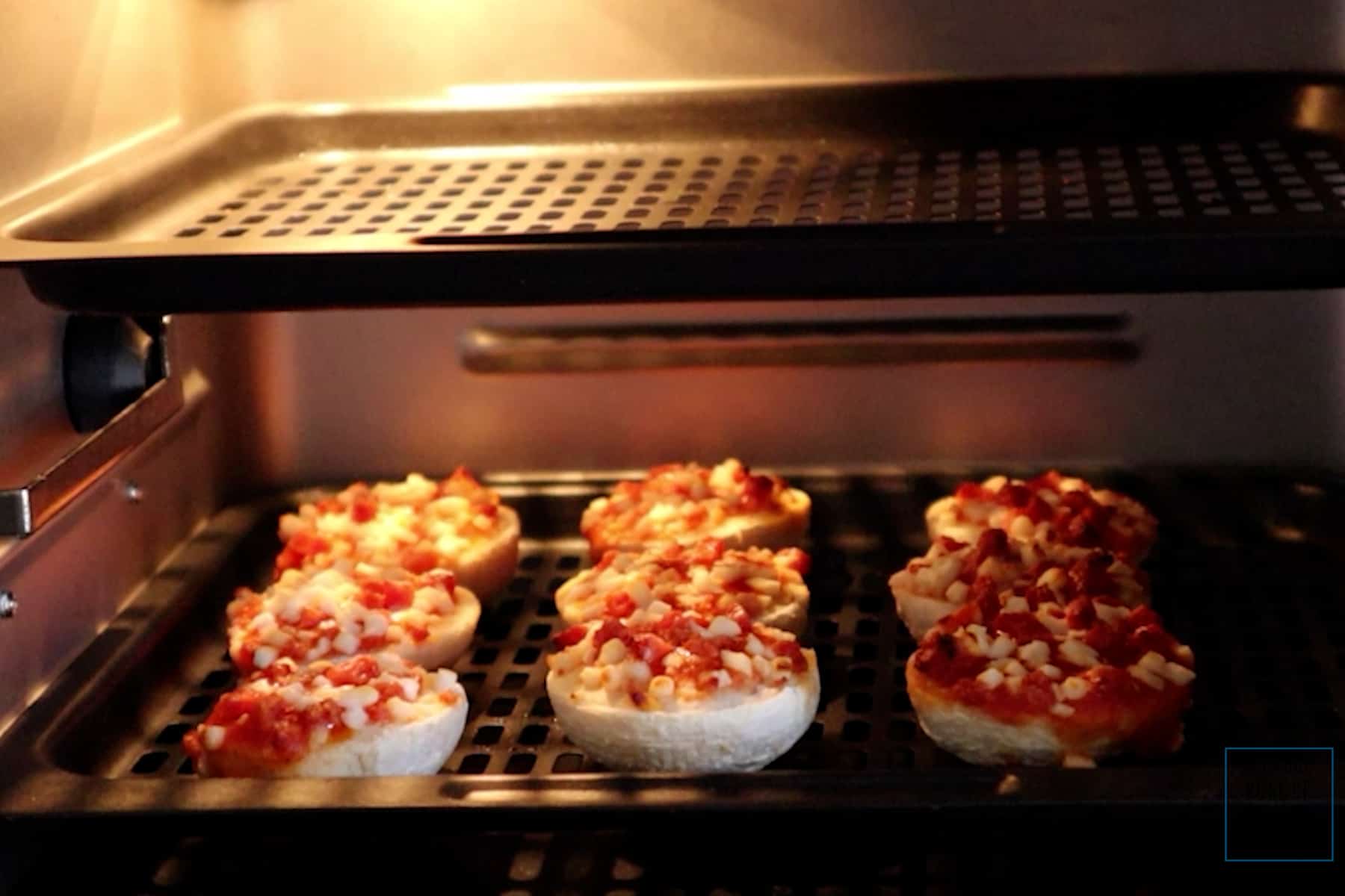 air fryer bagel bites in air fryer after cooking.