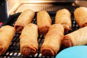 egg rolls after cooking on air fryer tray.