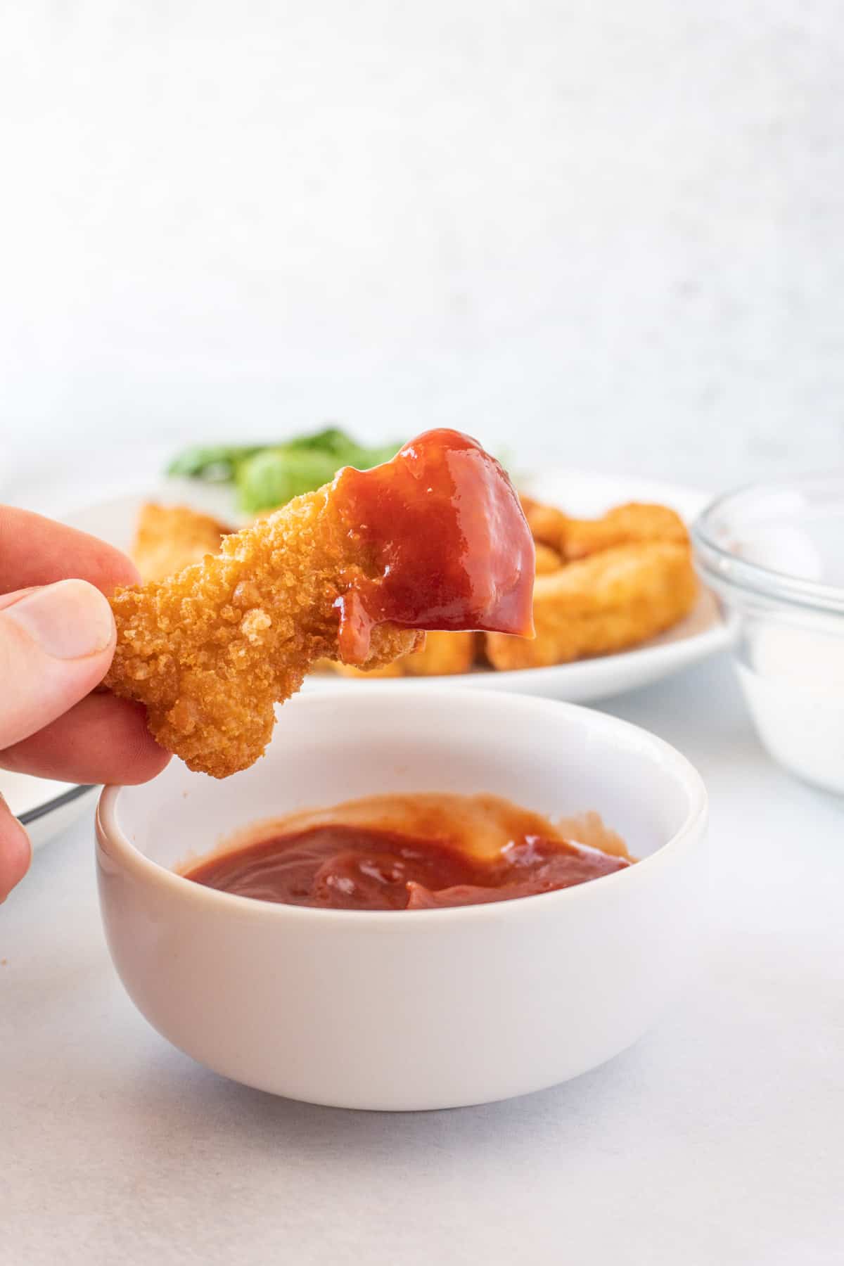 dino nugget dipped in ketchup.