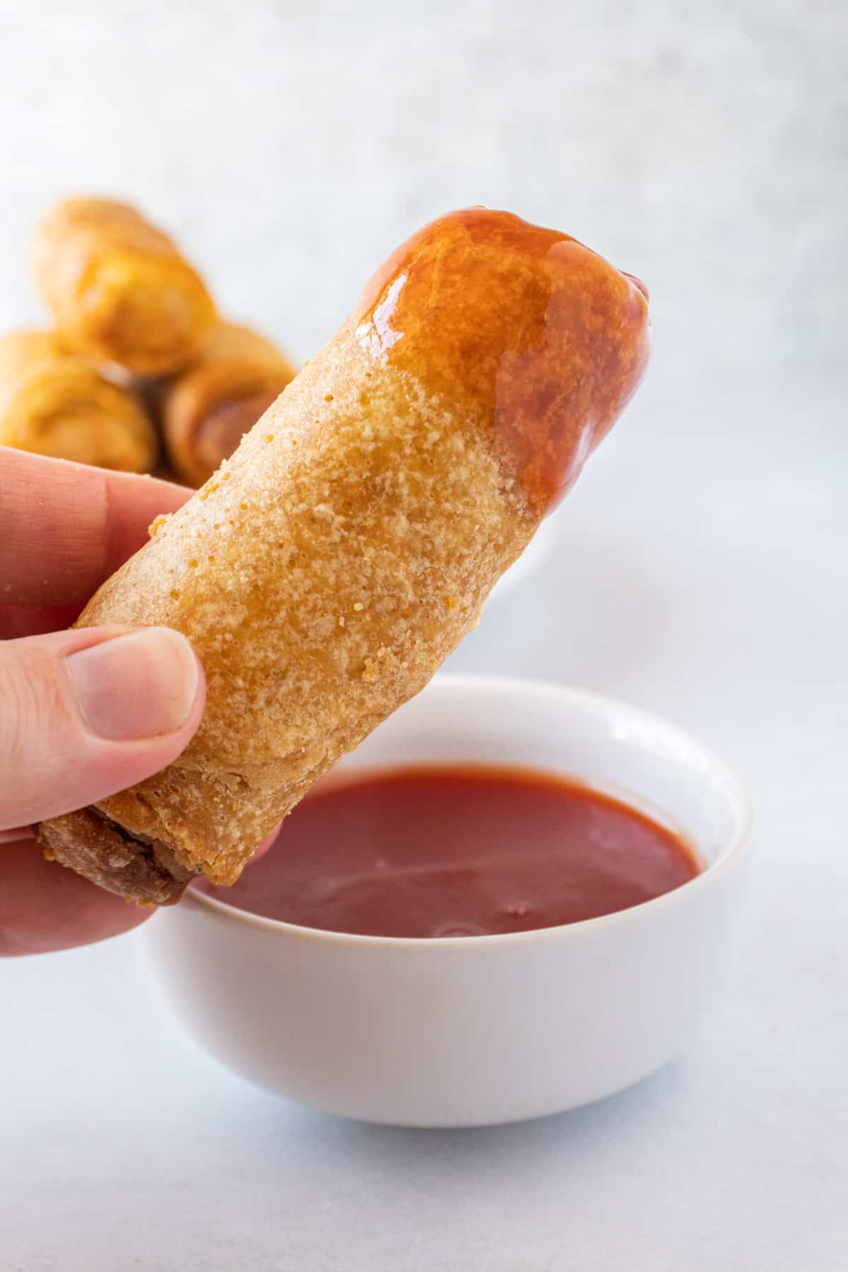 egg roll with sauce on it.