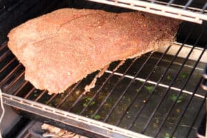 tri tip in smoker before being cooked.