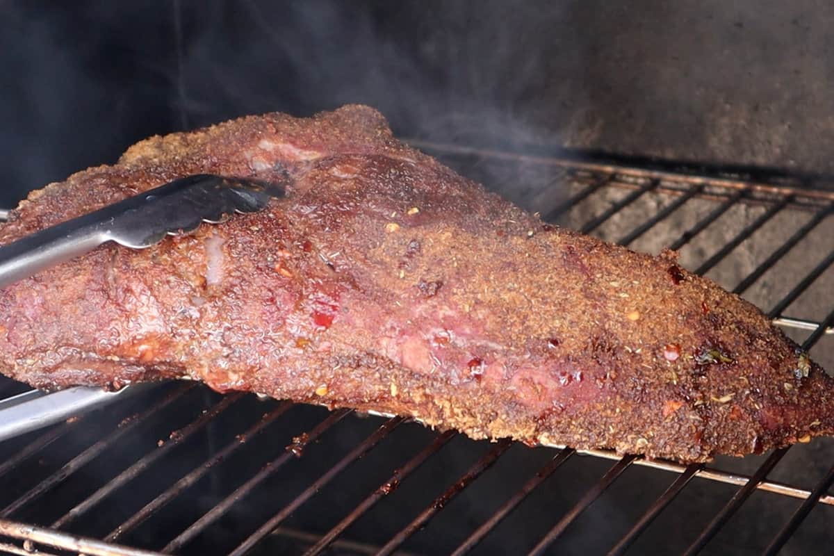 removing cooked tri tip from smoker.