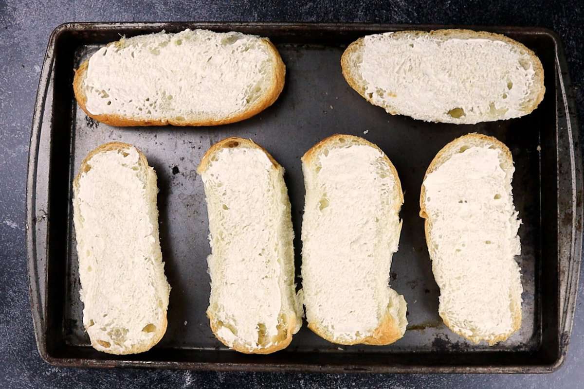 bread with mayo on it on pan.