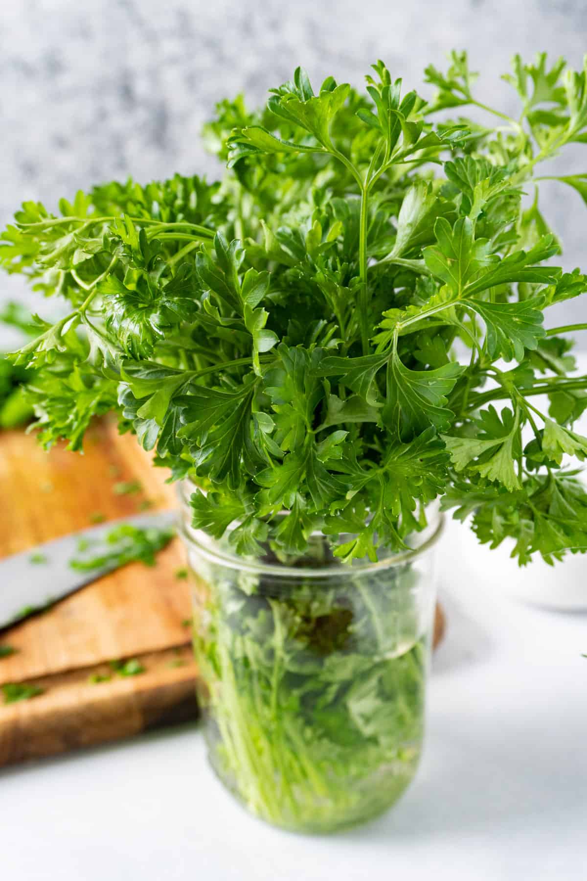 parsley bunch in a mason jar with water.