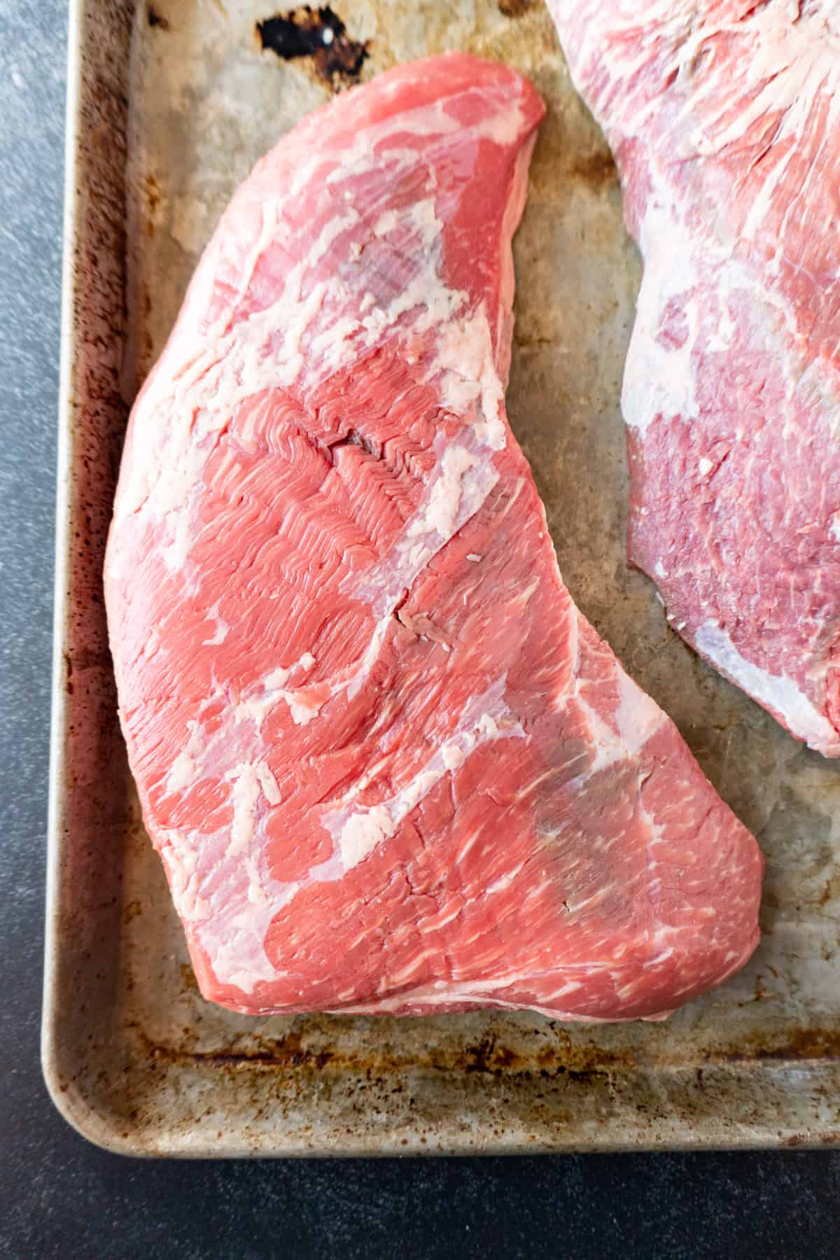 uncooked tri tip on baking sheet.