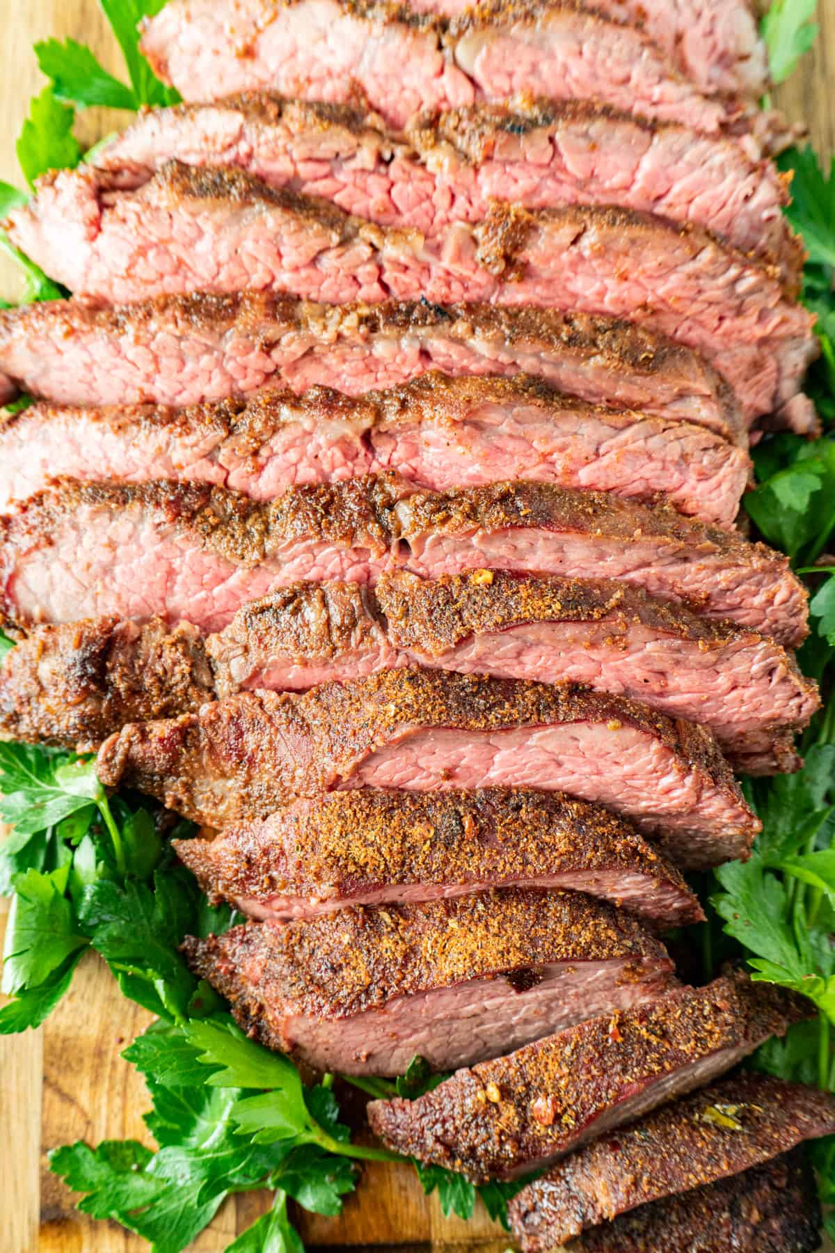 sliced tri tip with parsley around it.