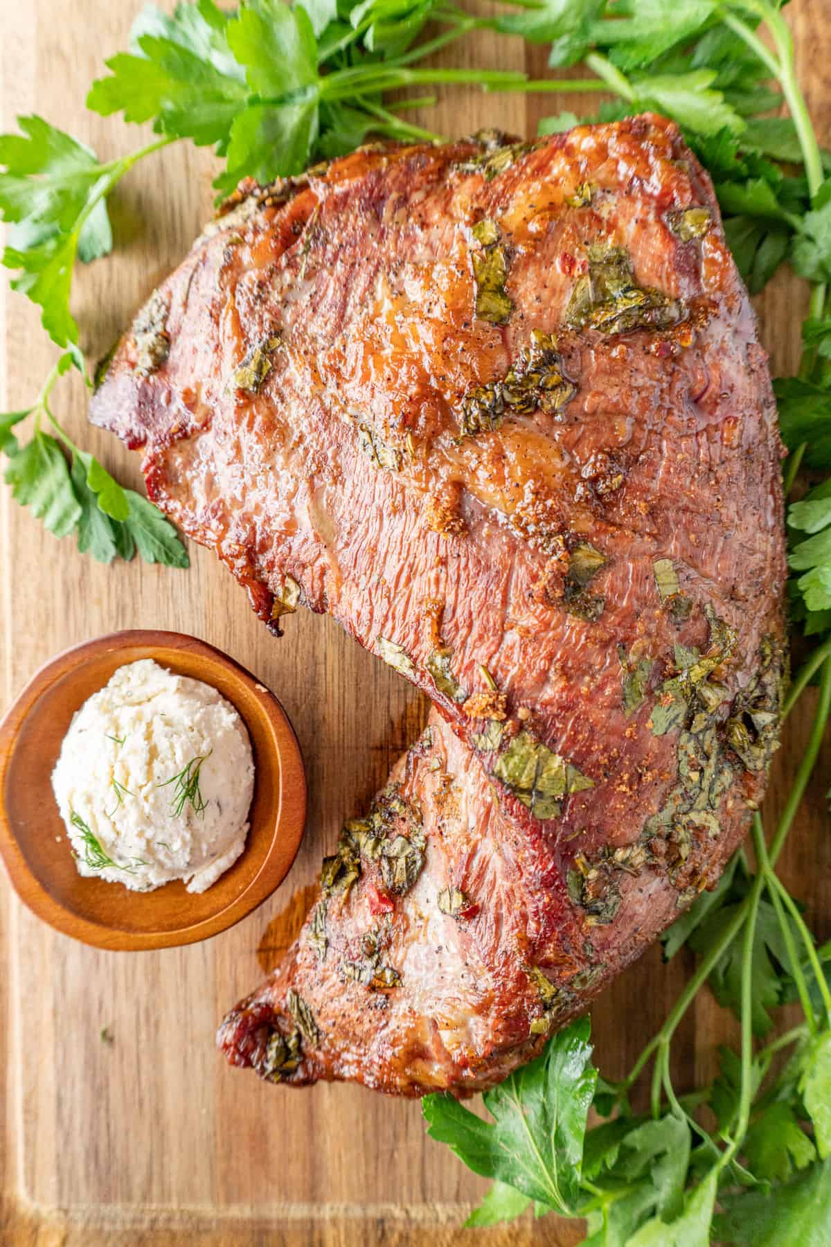 whole marinated and cooked tri tip on cutting board.