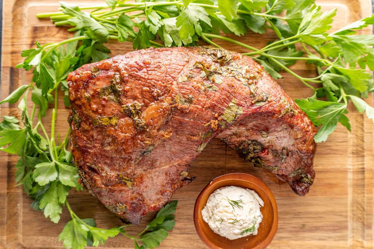 Whole cooked tri-tip on a cutting board.