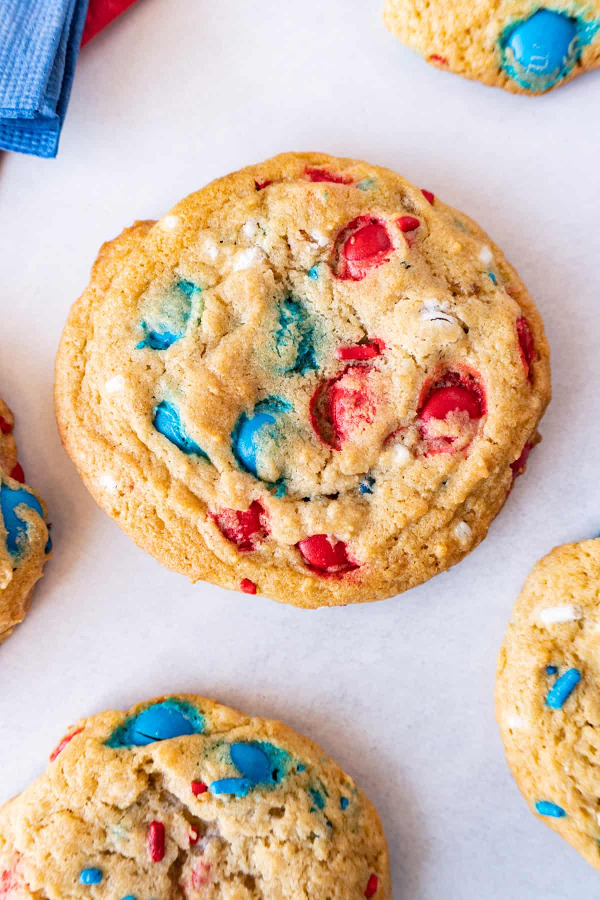 cookies with red, white, and blue candies baked into them on a white background.