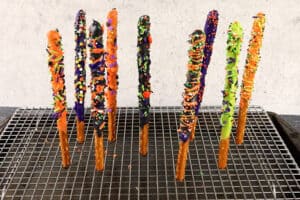 decorated pretzel rods upright in cooling rack