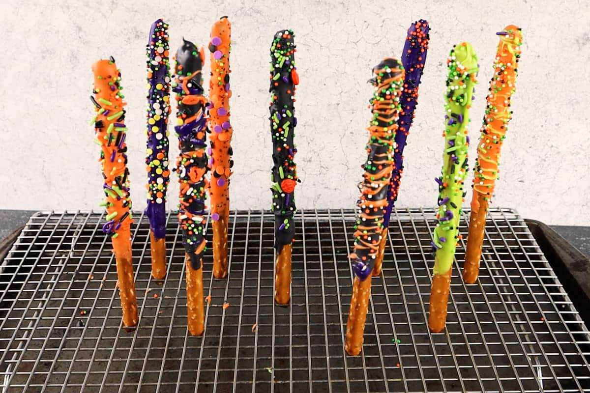 decorated pretzel rods upright in cooling rack