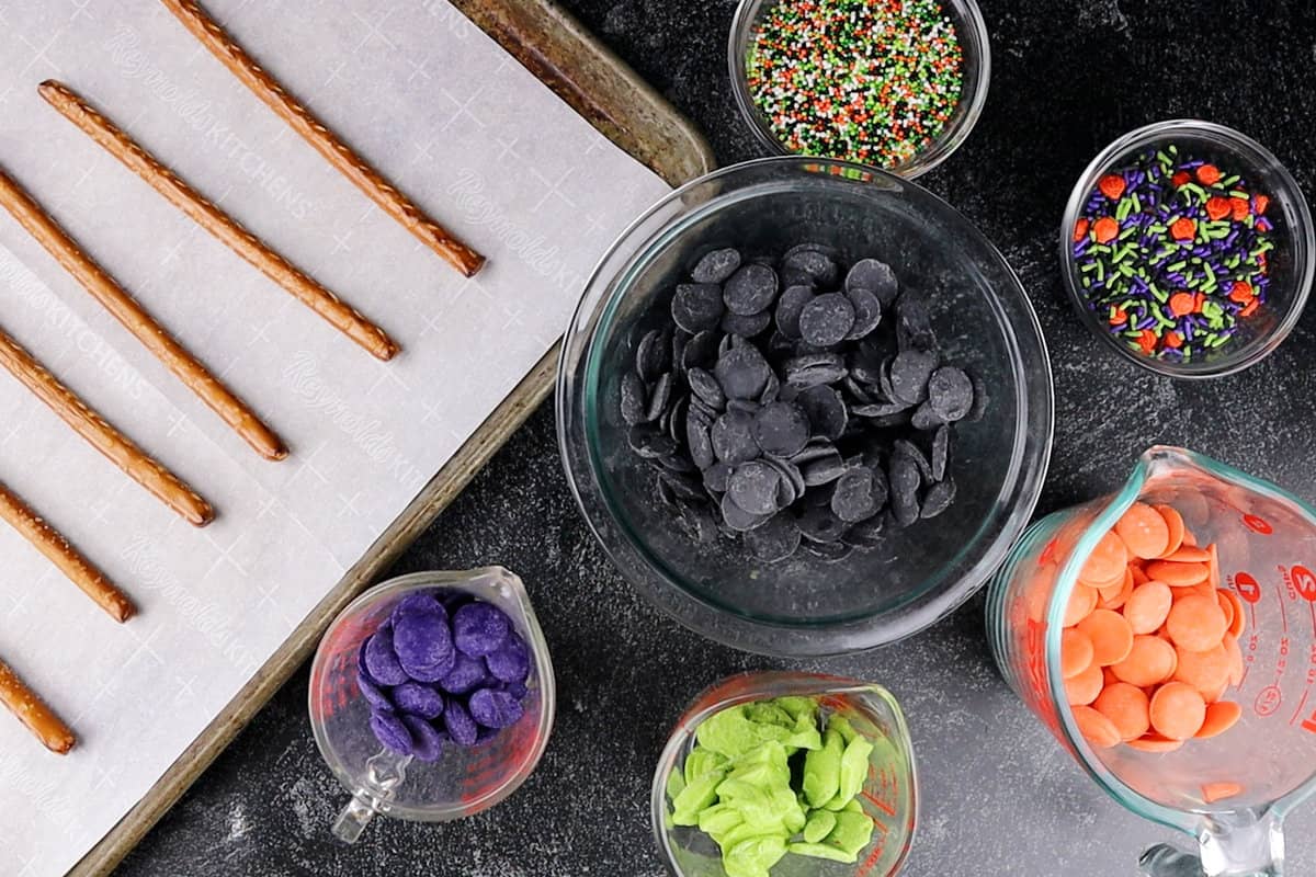 Halloween Pretzel Rods ingredients- colored candy melts, halloween sprinkls, pretzel rods