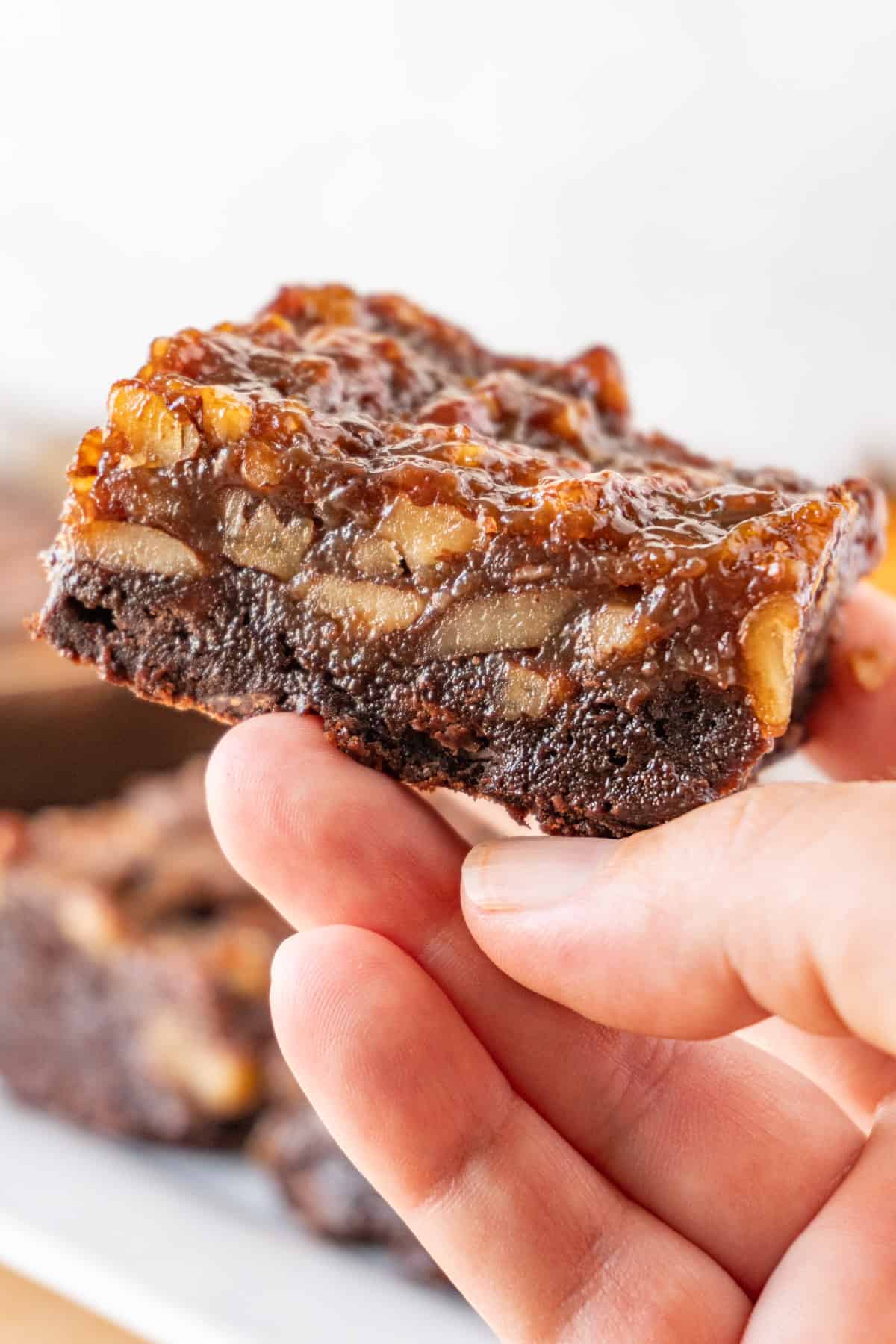 Holding Pecan Pie Brownie in hand