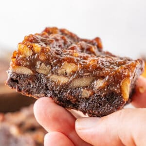 Pecan Pie Brownies featured image- holding brownie in hand