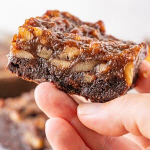 Pecan Pie Brownies featured image- holding brownie in hand